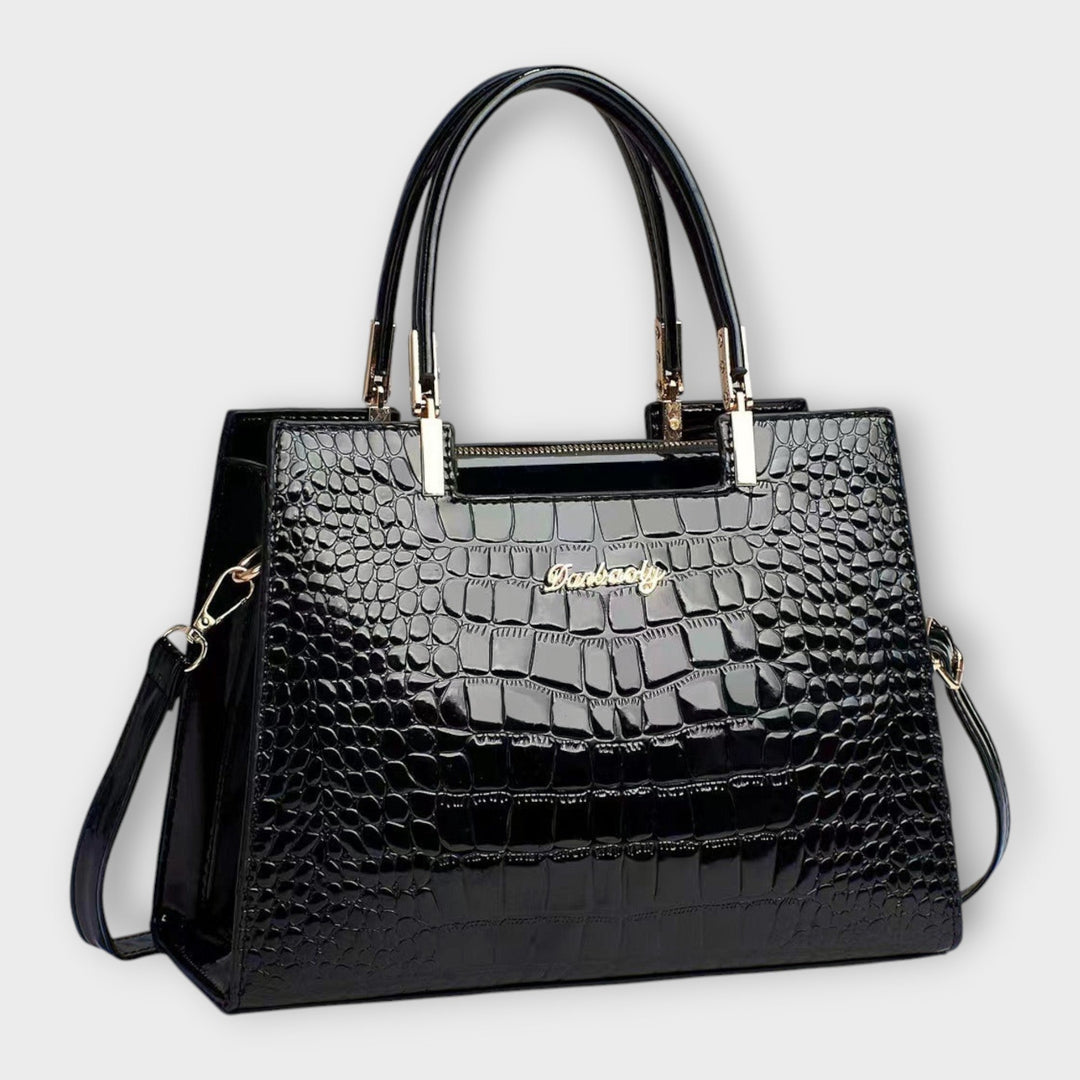 Solveig exclusive handbag in black with structured silhouette and shoulder strap on a clean background