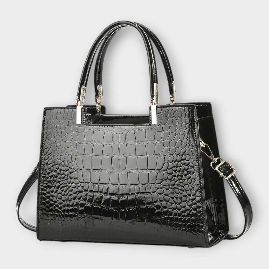 Close-up of Solveig handbag showing top handles and sleek exterior detail