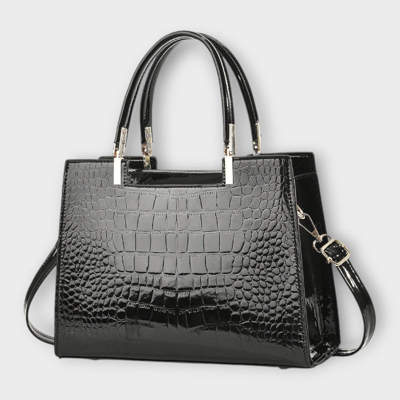 Close-up of Solveig handbag showing top handles and sleek exterior detail