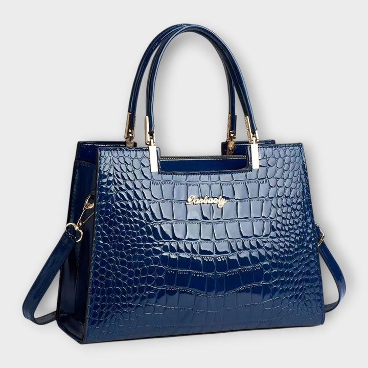 Lifestyle flat lay of the Solveig exclusive handbag alongside fashion accessories
