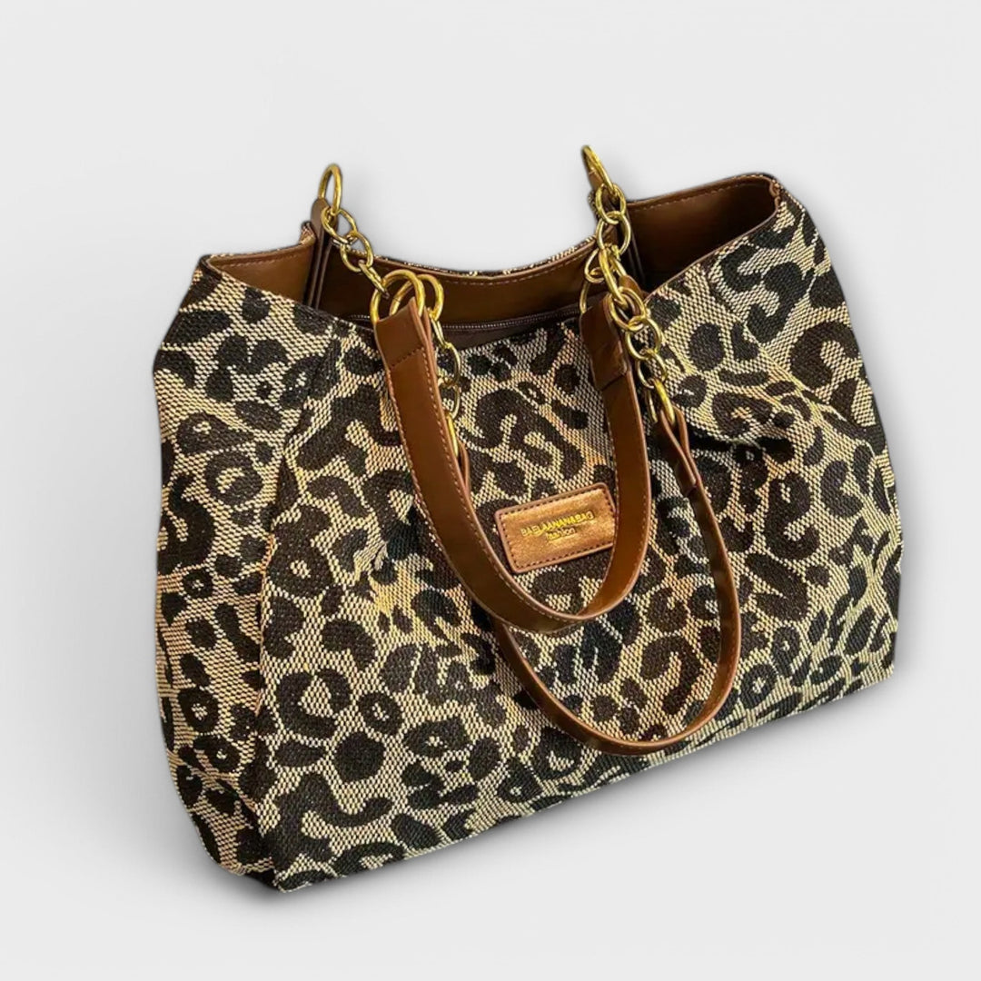 Leopard-print shoulder bag with top handle and adjustable strap, front view