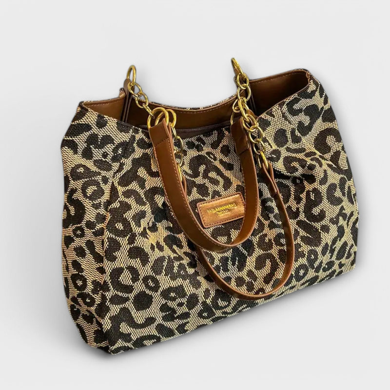 Leopard-print shoulder bag with top handle and adjustable strap, front view