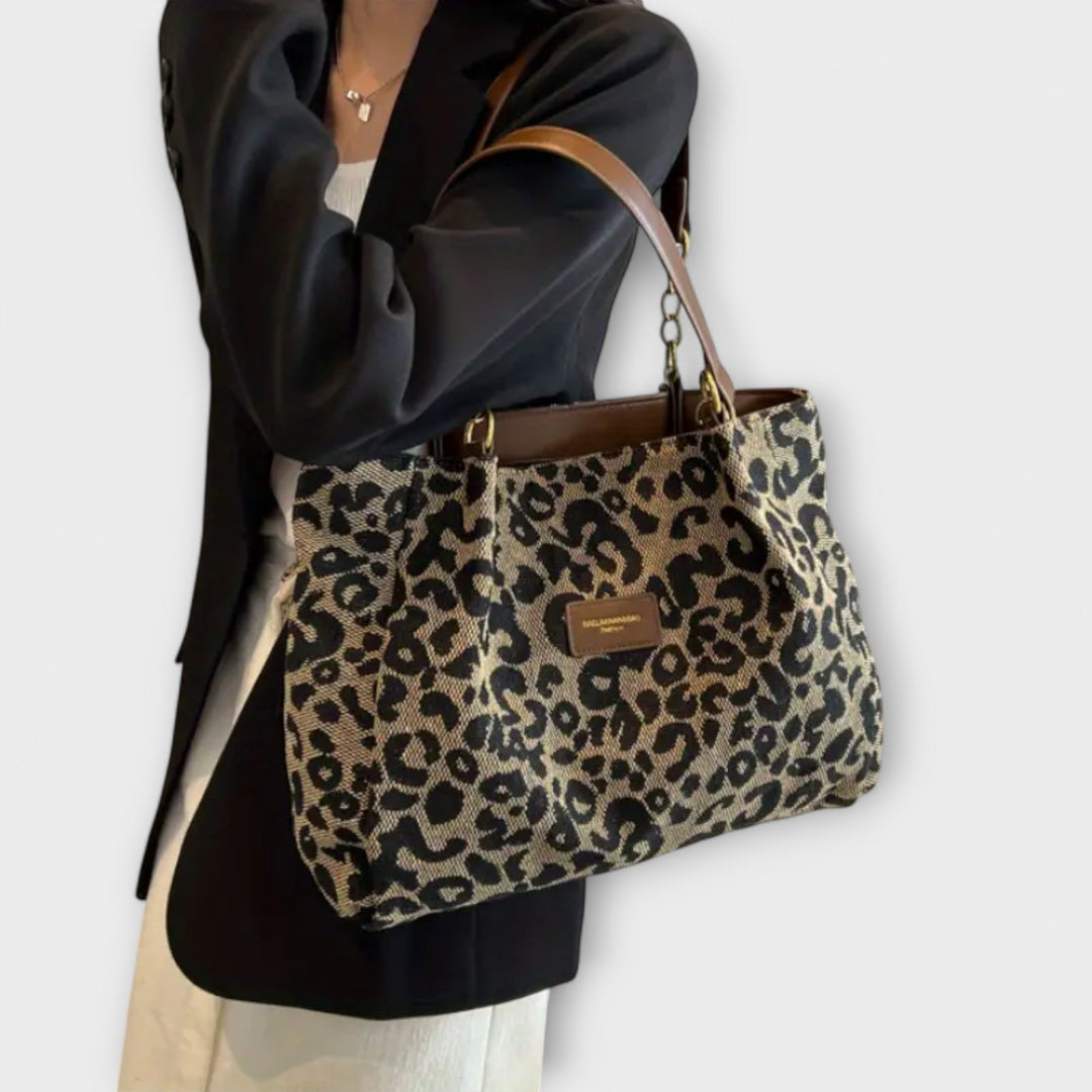 Leopard-print shoulder bag showing interior compartments and strap detail