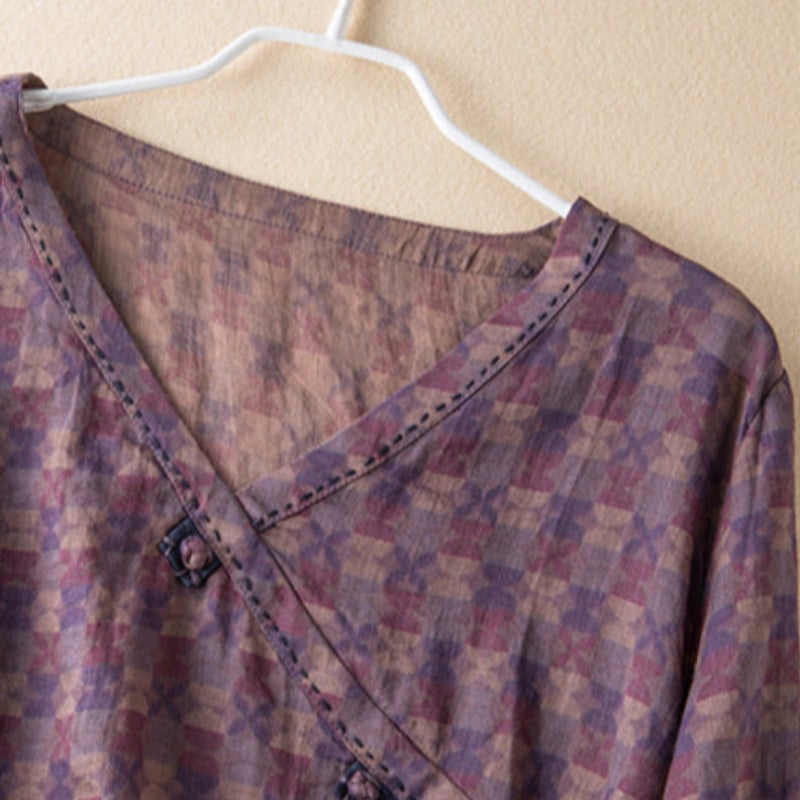 Close-up of delicate leaf and floral embroidery detail on the bodice of a relaxed woven shirt