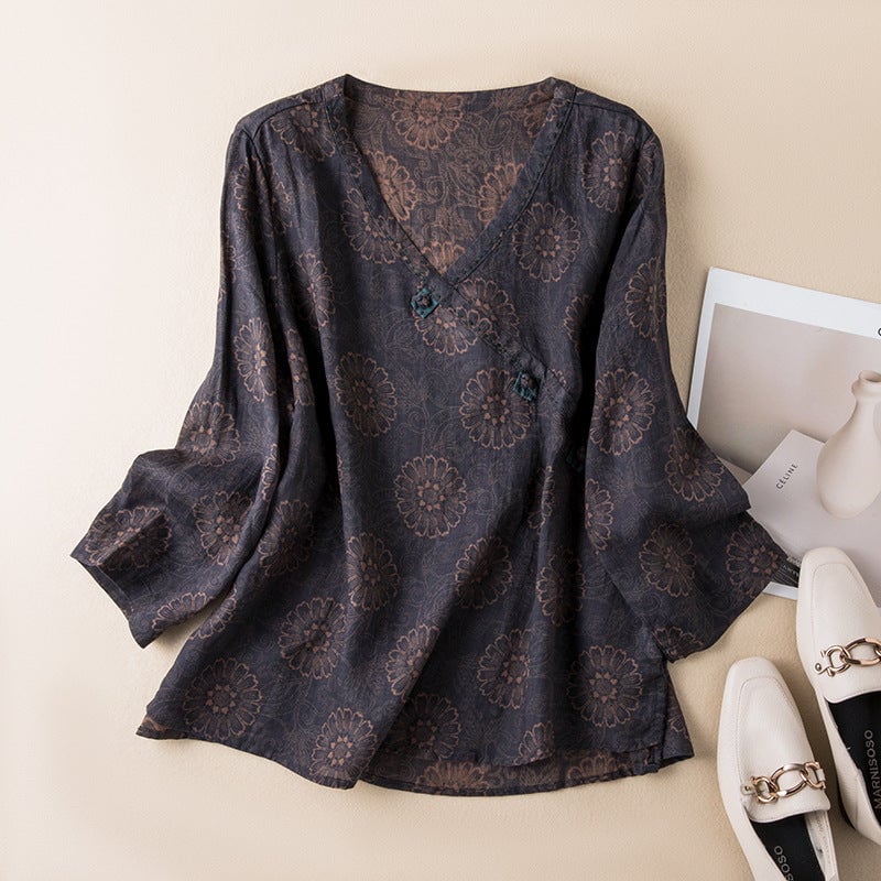 Flat lay of a button-front relaxed shirt showing embroidery detail across the hem