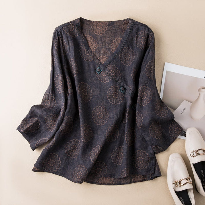 Flat lay of a button-front relaxed shirt showing embroidery detail across the hem
