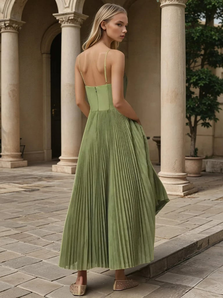 Close-up of the pleated skirt detail on an olive green maxi dress