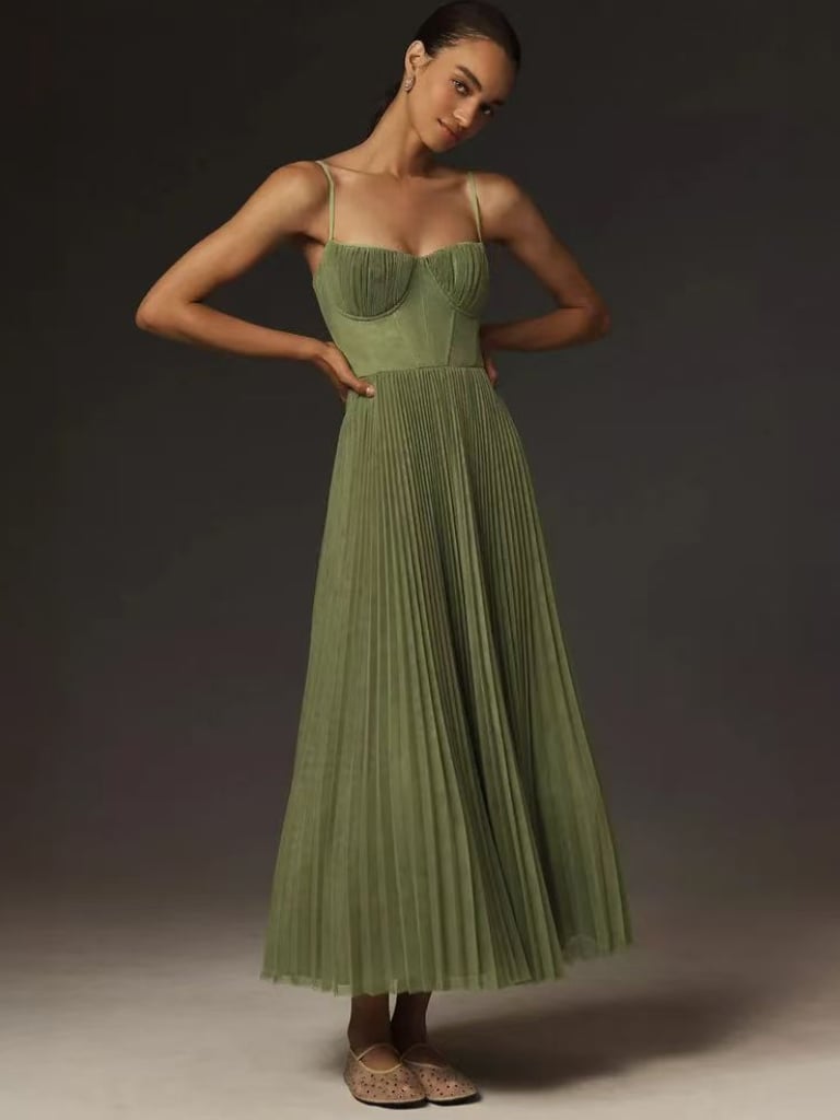 Close-up of the waist-defining bodice on the olive green pleated maxi dress