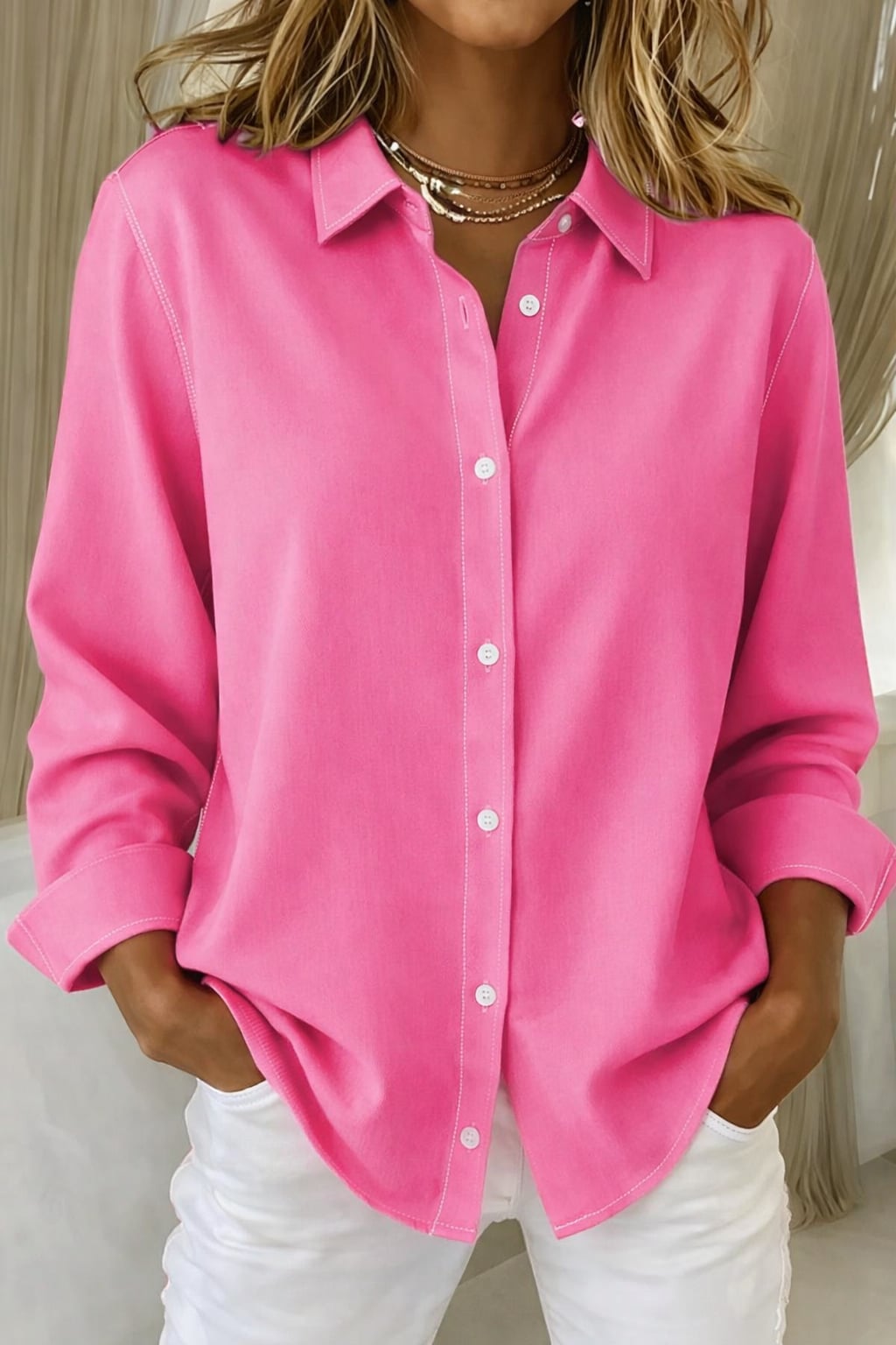 Model wearing the Sophie elegant button blouse in fuchsia with a structured collar and classic button-down front