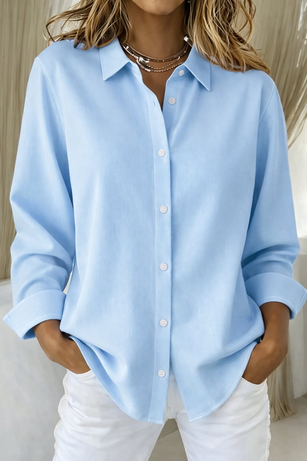 Flat lay of the Sophie elegant button blouse in blue displaying the collar and button placket detail