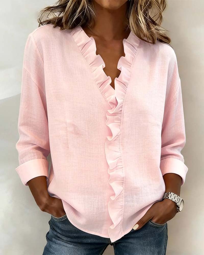 Woman wearing the Sophie ruffle V-neck long sleeve blouse in pink, front view