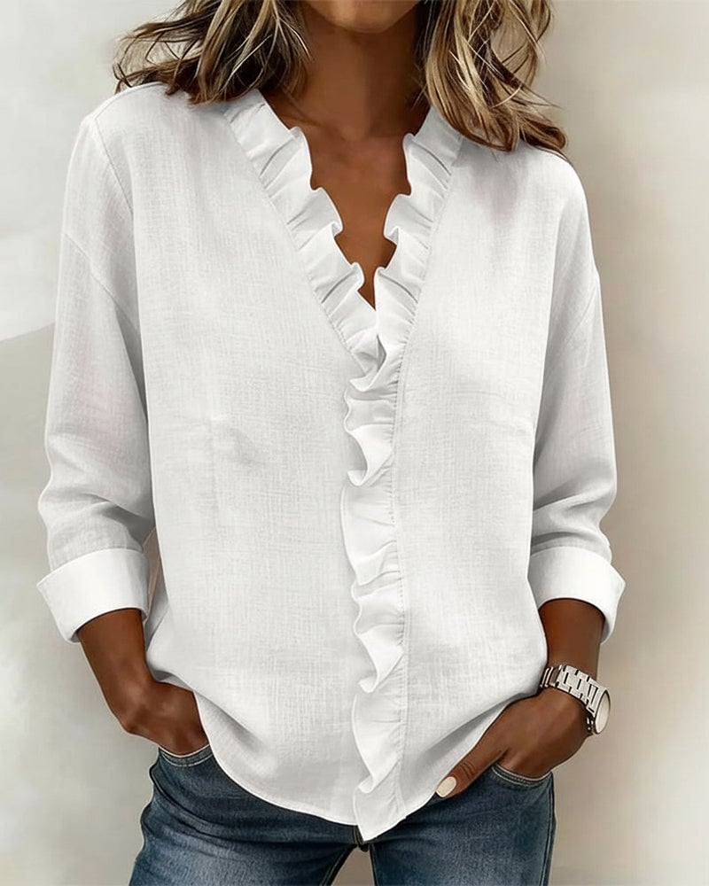 Close-up of the cascading ruffle V-neckline detail on the Sophie blouse in pink