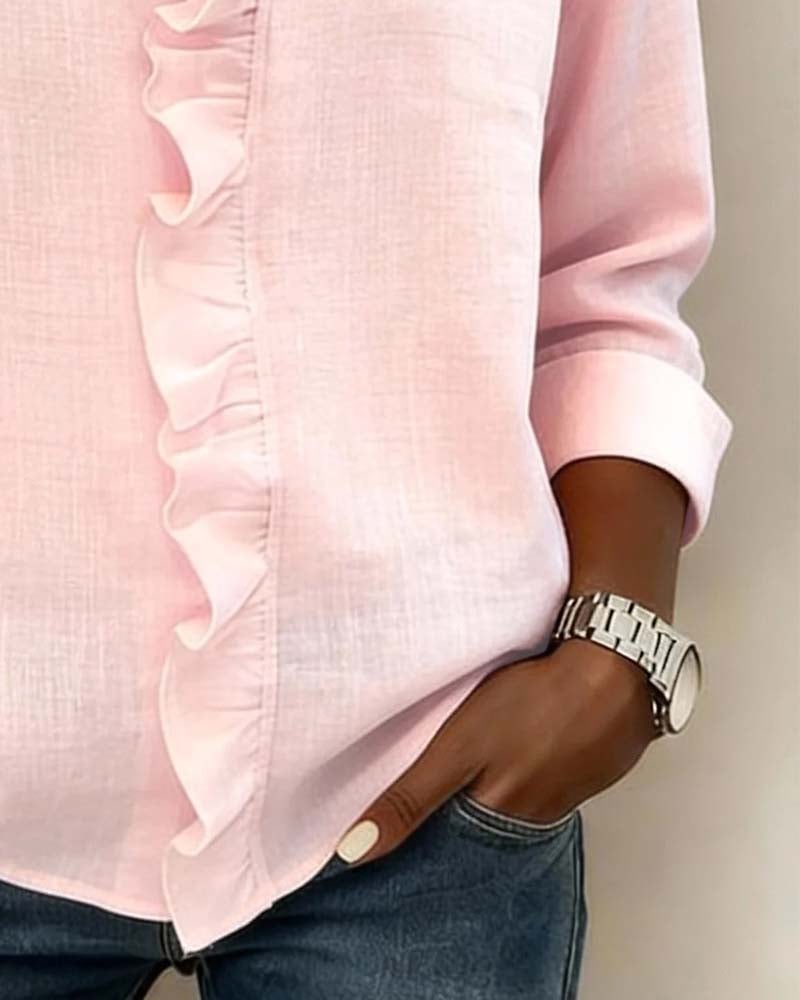 Woman wearing the Sophie ruffle V-neck blouse in white, front view