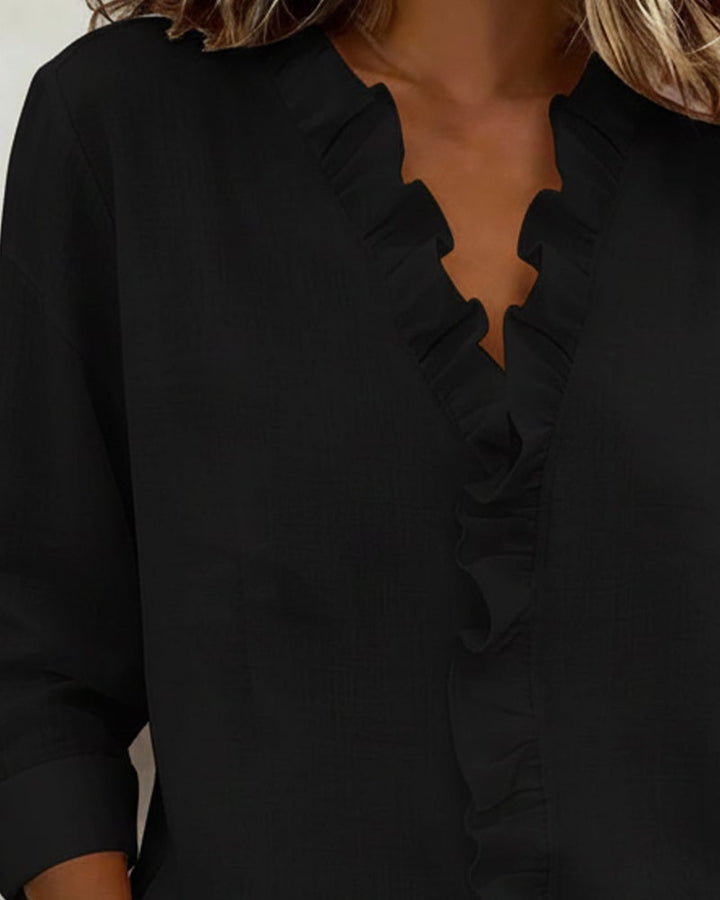 Flat lay of the Sophie ruffle long sleeve blouse showing pink, white, and black color options