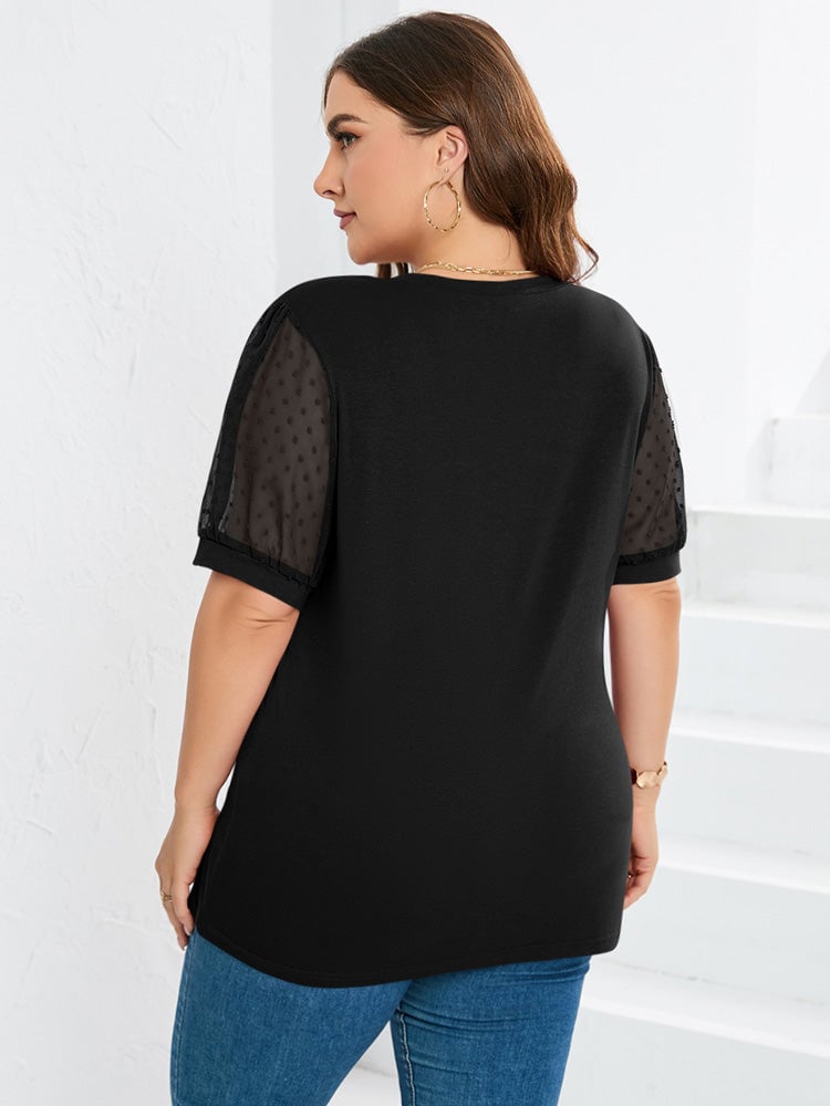 Model in the Sophora V-neck top in green, layered under a cardigan for a chic everyday outfit