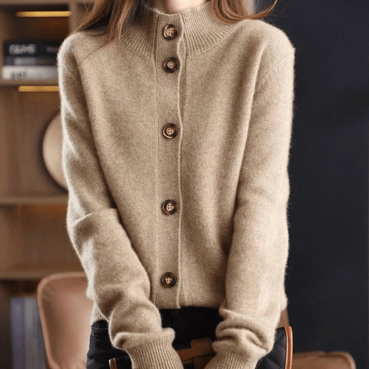 Flat lay of the Stella cardigan in multiple color options: orange, beige, brown, black, and dark blue