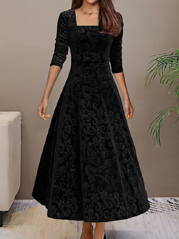 Woman wearing the Stella elegant dress in black, featuring a sculpted silhouette and plush fabric finish
