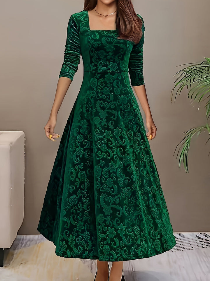 Close-up of the Stella elegant dress fabric texture in green, showcasing the rich, light-catching finish