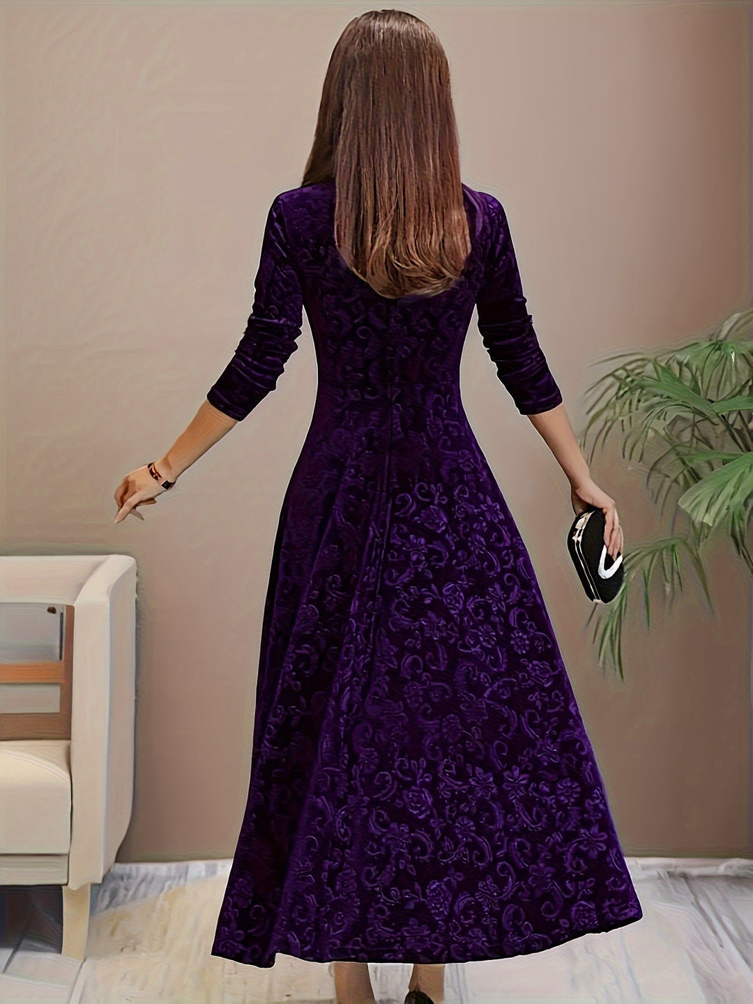 Model posing in the Stella elegant dress in purple at an evening event setting