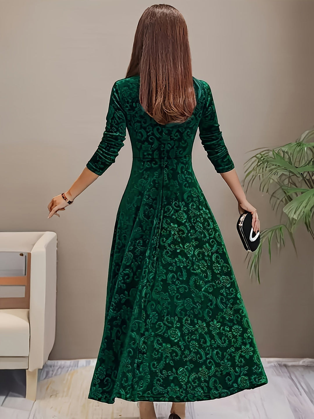 Detail shot of the Stella elegant dress neckline and sleeve in green, emphasizing luxurious construction