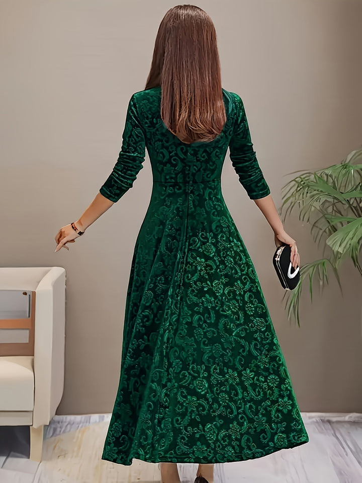 Detail shot of the Stella elegant dress neckline and sleeve in green, emphasizing luxurious construction