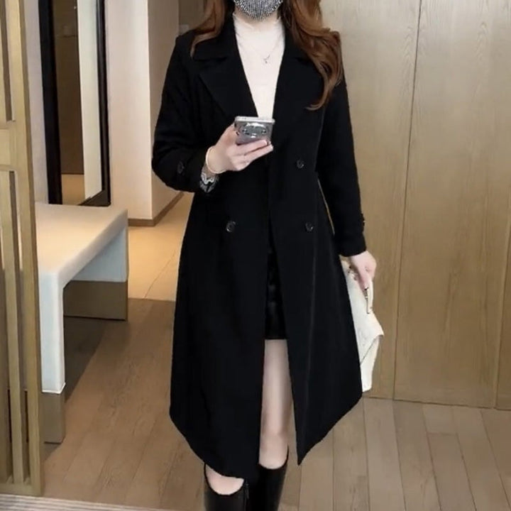 Model wearing the Stella sophisticated trench coat in khaki, belted at the waist, front view