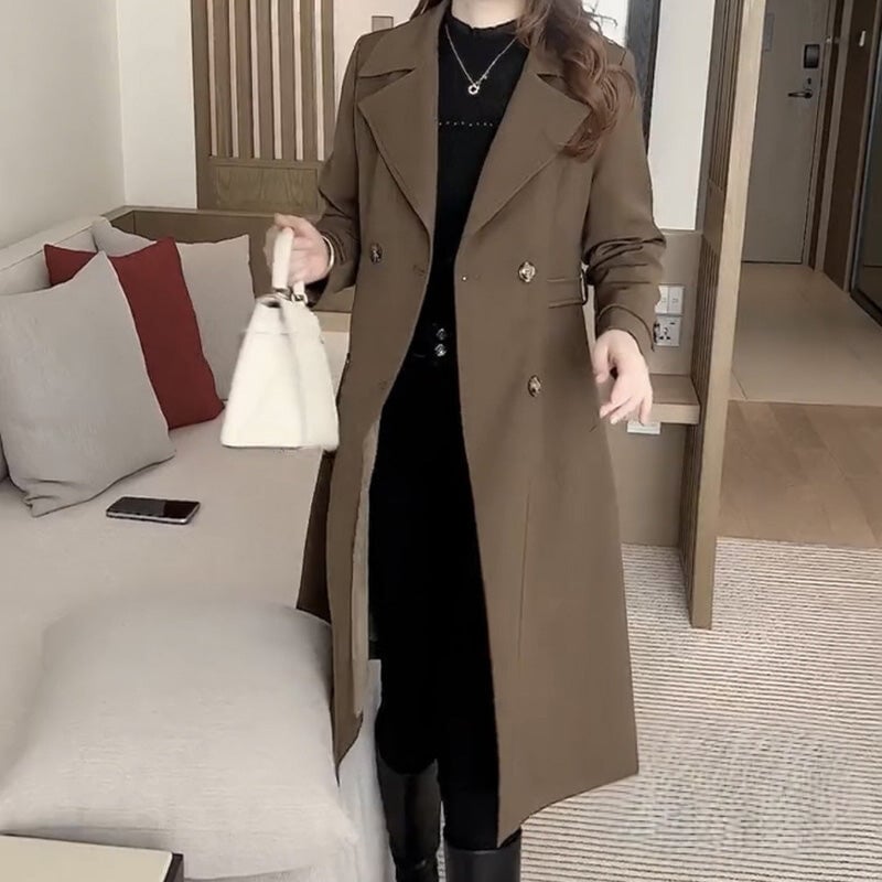 Model wearing the Stella trench coat in black, showing full-length silhouette