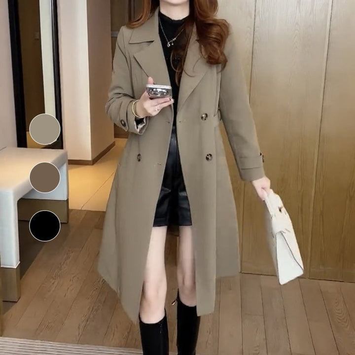Model wearing the Stella trench coat in brown, styled with trousers for a polished look