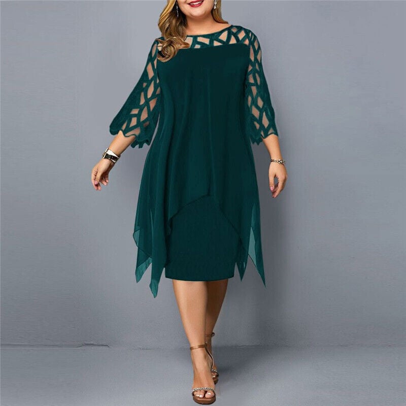 Woman in the Stella flowy midi dress in green, posing to show the relaxed fit through the waist and hips