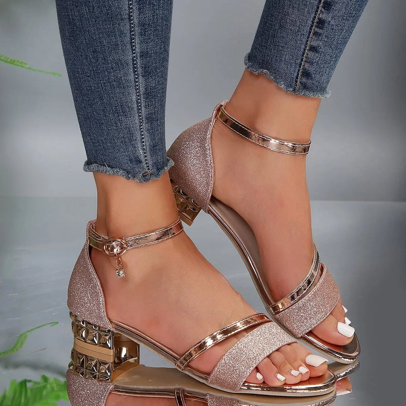 Close-up of jewel-encrusted stacked block heel on Stella sandal in black