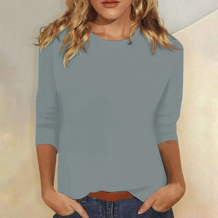 Close-up of the Stella top in blue highlighting the smooth solid fabric and sleeve detail