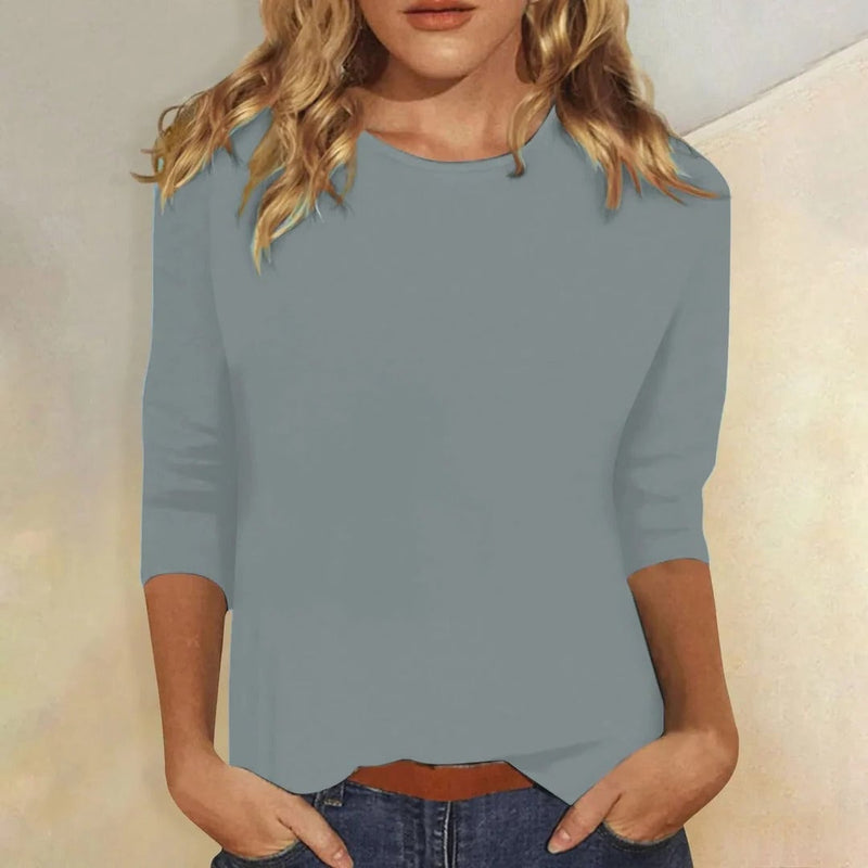 Close-up of the Stella top in blue highlighting the smooth solid fabric and sleeve detail