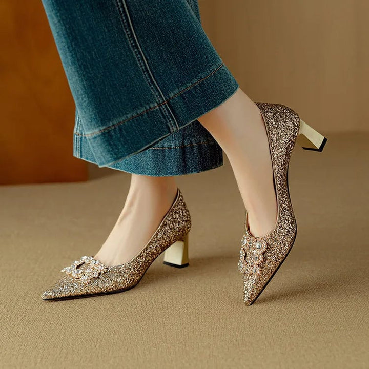 Stella gold glitter block heel pump with crystal rhinestone buckle and pointed toe, front view