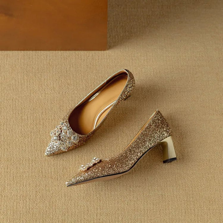 Stella gold glitter pumps pair laid flat on neutral background