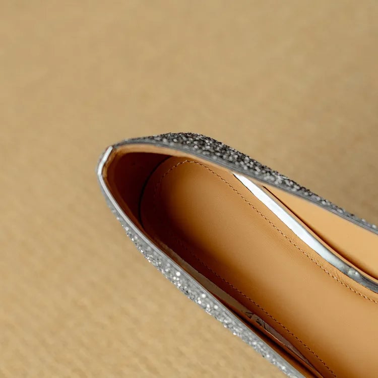 Stella silver glitter pump heel close-up highlighting sturdy block heel structure