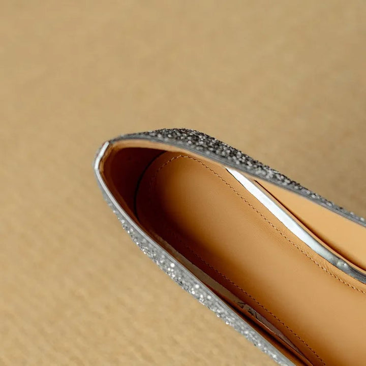 Stella silver glitter pump heel close-up highlighting sturdy block heel structure