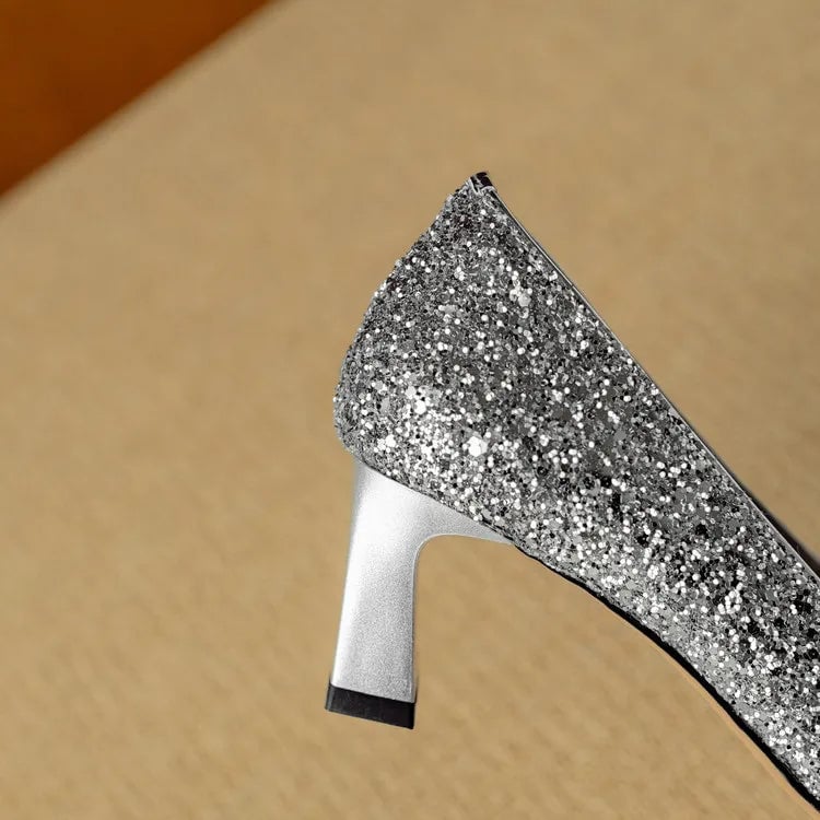 Stella silver glitter pumps pair laid flat on neutral background