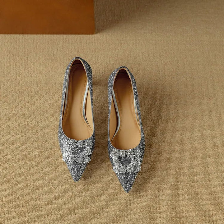 Stella silver glitter pumps styled with wide-leg trousers on model