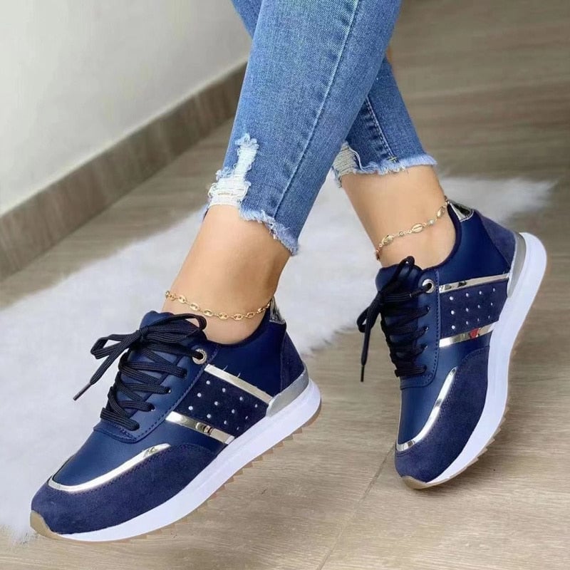 Stella women's lace-up fashion sneakers with metallic gold stripe detail on navy upper and white sole