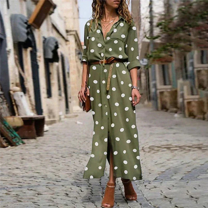 Woman wearing a black polka dot long sleeve maxi shirt dress with a V-neckline and button-down front, styled with sandals