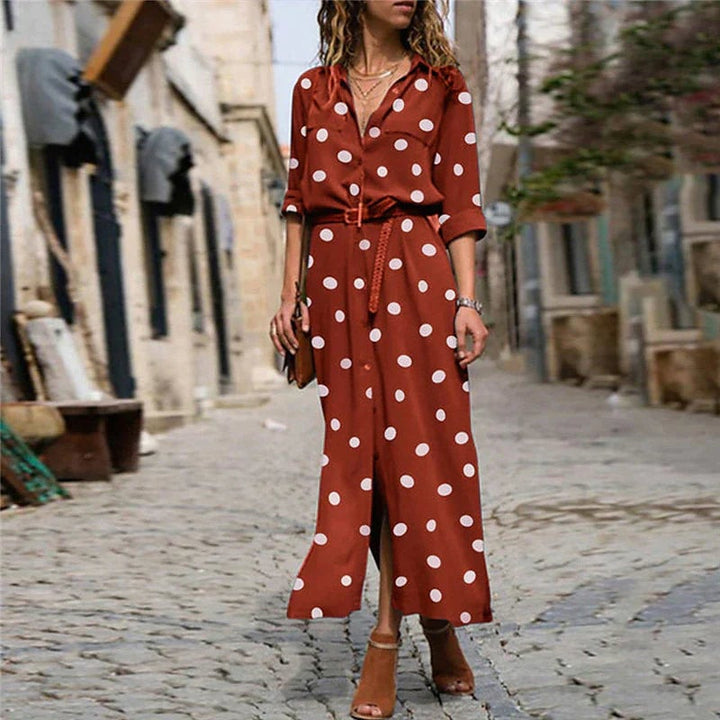 Full-length view of the Stella polka dot maxi dress in navy blue showing the front slit and relaxed silhouette