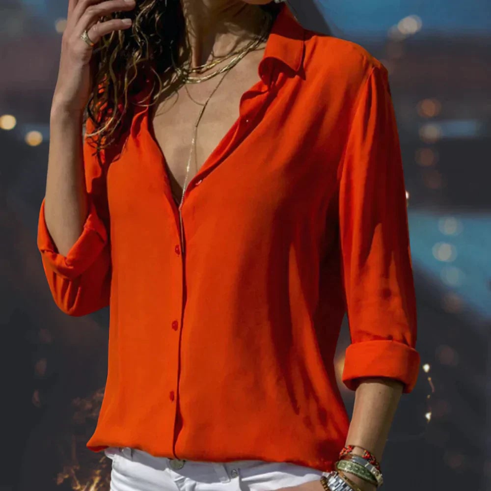 Close-up of the Stella satin blouse showing button-front closure and soft sheen fabric detail