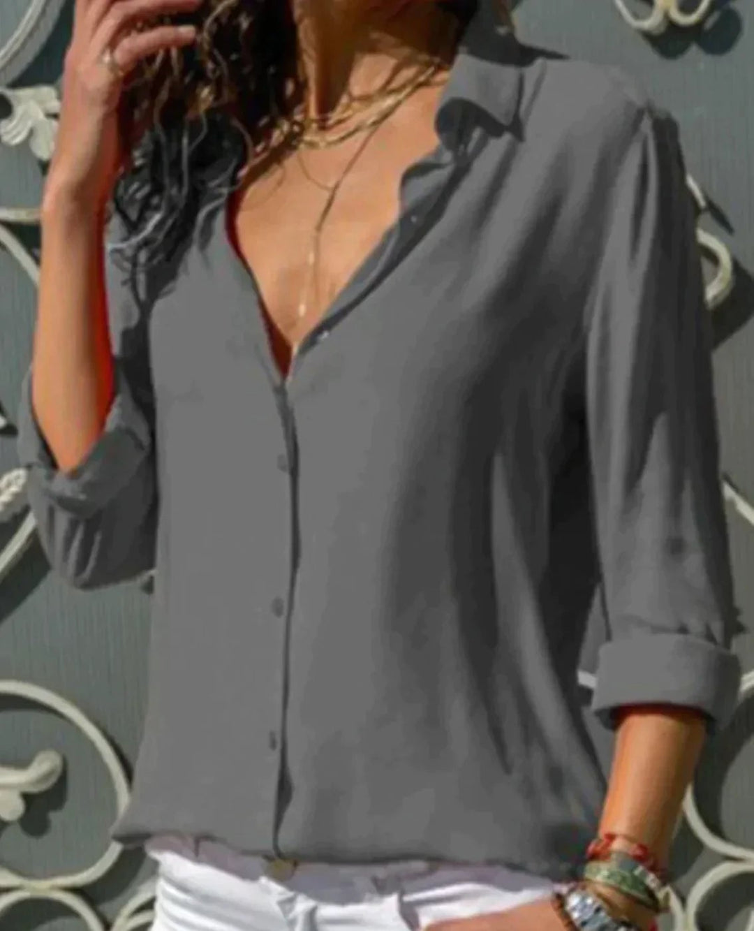 Flat lay of the Stella satin blouse in black showing full-length sleeves and collar detail