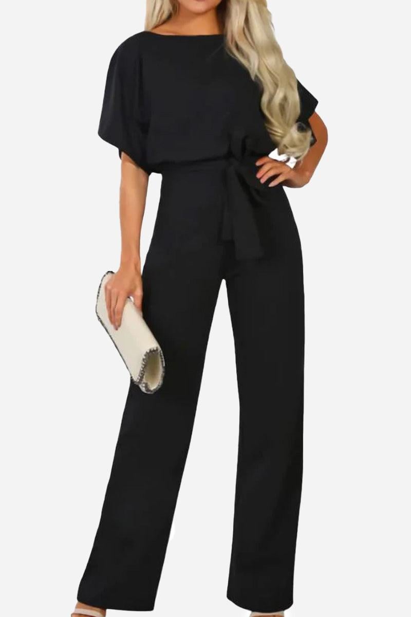 Woman wearing the Stella wide-leg belted jumpsuit in black with batwing sleeves and self-tie waist belt