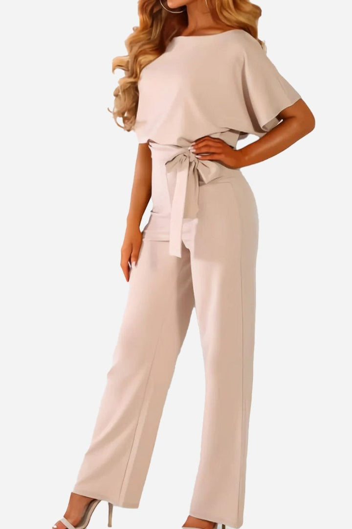 Front view of the Stella belted jumpsuit in black showing the wide-leg cut and round neckline