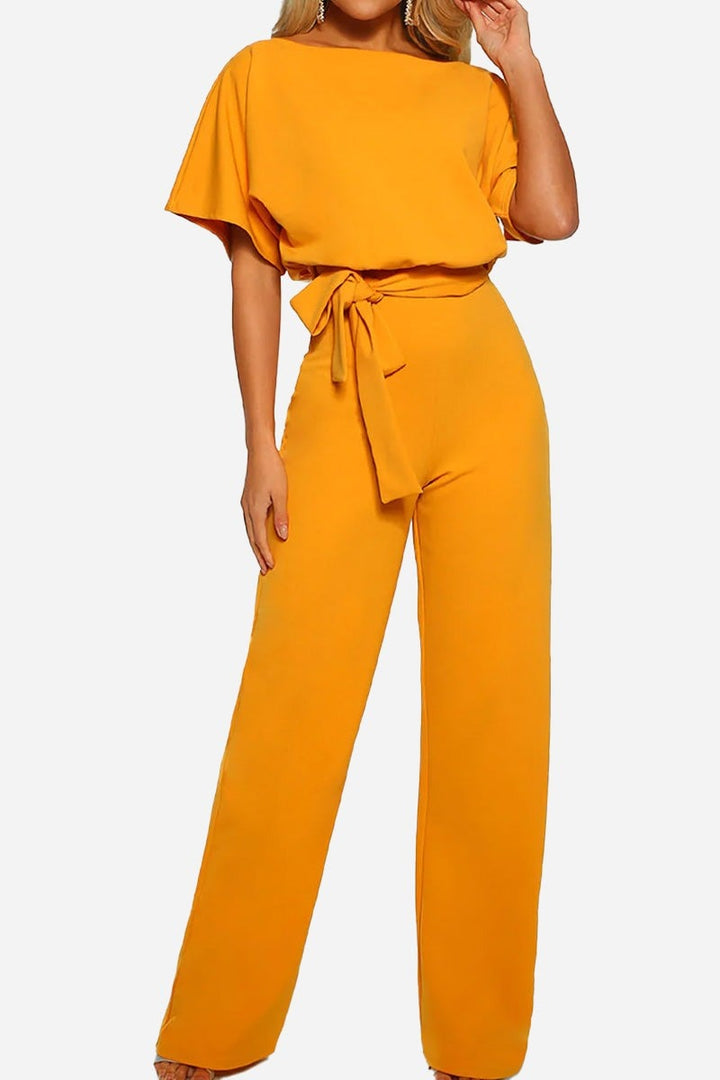 Side view of the Stella jumpsuit highlighting the cinched tie waist and flowing wide-leg pants