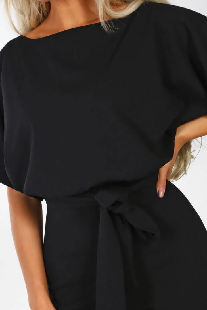 Stella jumpsuit in light pink showing the relaxed batwing sleeves and wide-leg pants