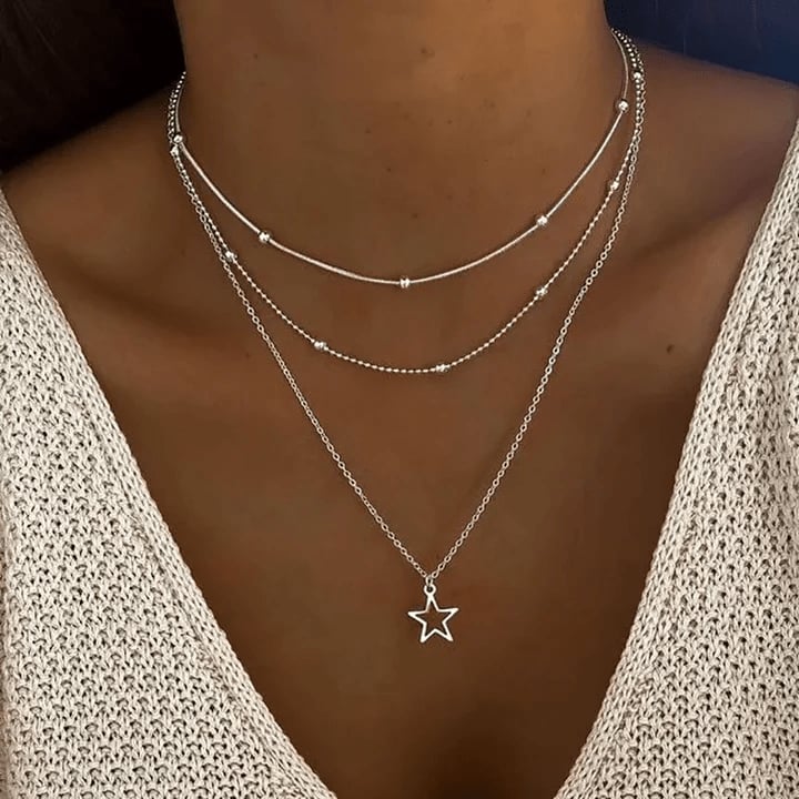 Vintage-inspired gold star pendant necklace displayed on a clean white background