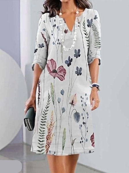 Close-up of delicate floral print fabric detail on a lightweight tunic dress
