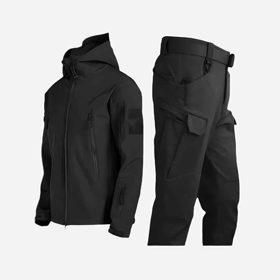 Women wearing a waterproof black outdoor jacket and pants set in a snowy winter landscape